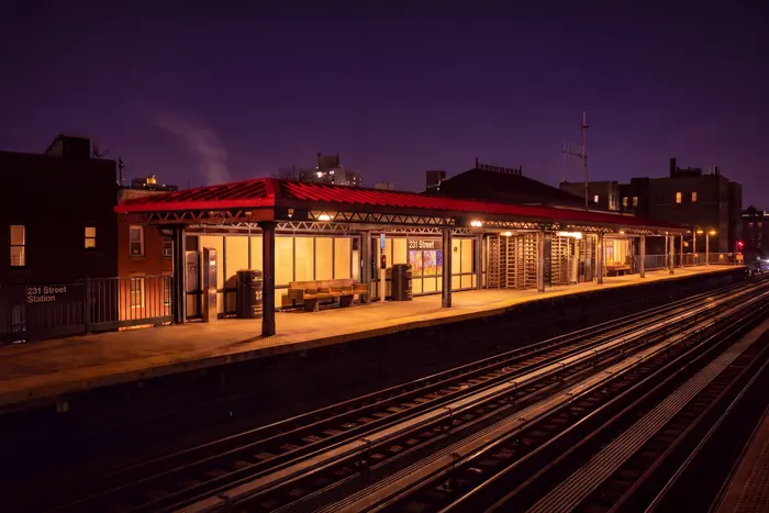 An elevated platform at night under a red canopy